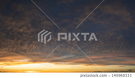 Beautiful sunset sky scenery. Bright colorful orange and yellow clouds on horizon Beautiful sunset sky scenery. Bright colorful orange and yellow clouds on horizon 140968331