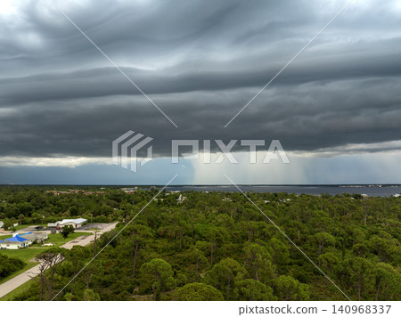 Seasonal tropical rainstorm above Charlotte Harbor. Storm clouds and rain showers drenching Florida Gulf Coast town. Seasonal tropical rainstorm above Charlotte Harbor. Storm clouds and rain showers drenching Florida Gulf Coast town. 140968337