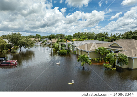 Flooded houses from hurricane rainfall water in Florida residential community. Aftermath of natural disaster in USA south Flooded houses from hurricane rainfall water in Florida residential community. Aftermath of natural disaster in USA south 140968344