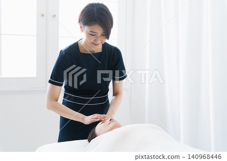 A young woman receiving treatment from an esthetician. Beauty image A young woman receiving treatment from an esthetician. Beauty image 140968446