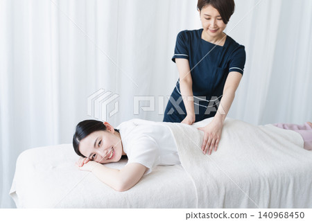 Young woman receiving massage from therapist Beauty image Young woman receiving massage from therapist Beauty image 140968450