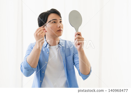 Young man using eyebrow cone concealer Beauty image Young man using eyebrow cone concealer Beauty image 140968477
