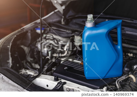 Car engine oil change service maintenance in garage workshop concept, Gear lubricant oil replace. Car engine oil change service maintenance in garage workshop concept, Gear lubricant oil replace. 140969374