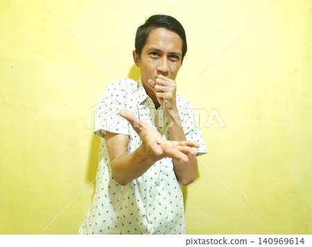 Young Asian Man Feeling Stressed with Headache Against Yellow Wall Young Asian Man Feeling Stressed with Headache Against Yellow Wall 140969614