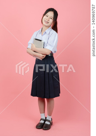 Portrait Thai student in uniform, Asian teen girl cute pretty cheerful happy smiling with tablet 140969787