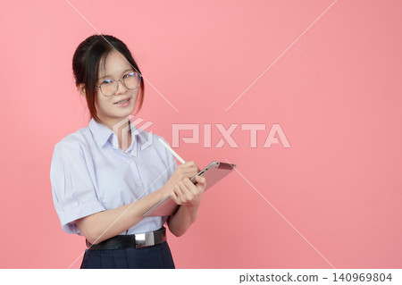 Thai Student eyeglasses uniform with tablet, Asian teen girl cute pretty happy smiling learning. Thai Student eyeglasses uniform with tablet, Asian teen girl cute pretty happy smiling learning. 140969804