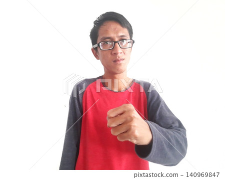 Energetic Asian Man in Batik Showing Hands with Surprised Expression Energetic Asian Man in Batik Showing Hands with Surprised Expression 140969847