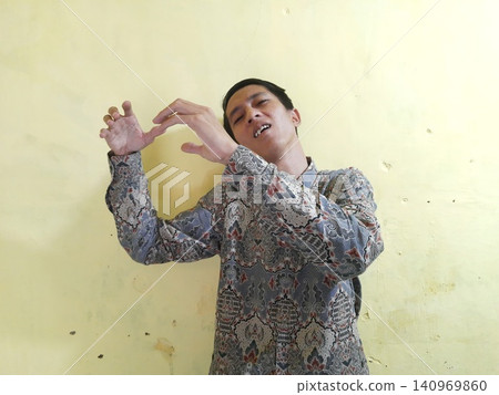 Energetic Asian Man in Batik Showing Hands with Surprised Expression Energetic Asian Man in Batik Showing Hands with Surprised Expression 140969860