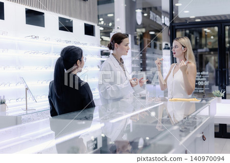 Optical store, Glasses shop staff service customer eyeglasses, Professional eyewear consultation 140970094