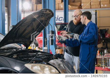 Car engineer technician worker, Technician team use laptop computer for tuning ECU with software. Car engineer technician worker, Technician team use laptop computer for tuning ECU with software. 140970193