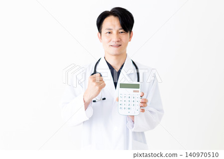 A middle-aged male doctor in a white coat makes a triumphant gesture while holding a calculator. A middle-aged male doctor in a white coat makes a triumphant gesture while holding a calculator. 140970510