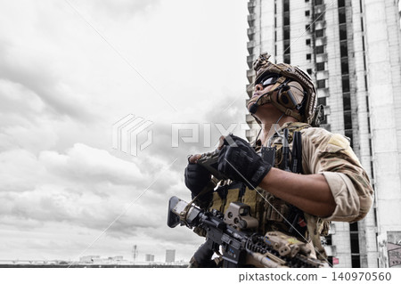 Special forces soldier operating military drone with remote control tactical attack distance enemy Special forces soldier operating military drone with remote control tactical attack distance enemy 140970560
