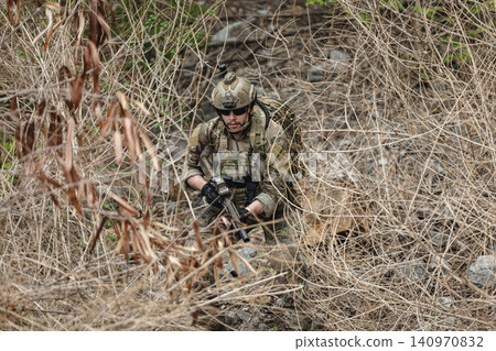 Military rangers, US Marine engaged in jungle combat operation deep in tropical forest 140970832