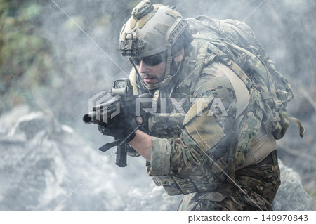 US Marine, Military Special forces soldier under heavy enemy fire intense battlefield engagement US Marine, Military Special forces soldier under heavy enemy fire intense battlefield engagement 140970843