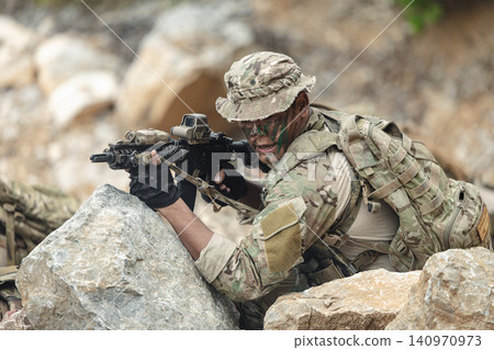 US Marine, Military Special forces soldier under heavy enemy fire intense battlefield engagement US Marine, Military Special forces soldier under heavy enemy fire intense battlefield engagement 140970973