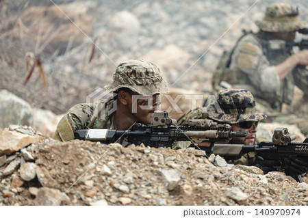 US Marine, Military Special forces soldier under heavy enemy fire intense battlefield engagement US Marine, Military Special forces soldier under heavy enemy fire intense battlefield engagement 140970974