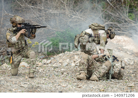 Marine Special Forces commando providing soldier injured evacuation assistance during military operation Marine Special Forces commando providing soldier injured evacuation assistance during military operation 140971206