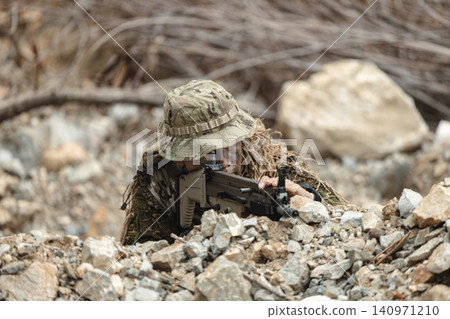 US Military marksman in camouflage ghillie suit conducting precision sniper operation US Military marksman in camouflage ghillie suit conducting precision sniper operation 140971210