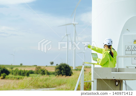 Engineers team working field outdoor with safety, Wind turbines clean energy power station service. Engineers team working field outdoor with safety, Wind turbines clean energy power station service. 140971412