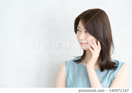 一位日本女子麵帶微笑地撫摸著別人的肌膚。 一位日本女子麵帶微笑地撫摸著別人的肌膚。 140972187