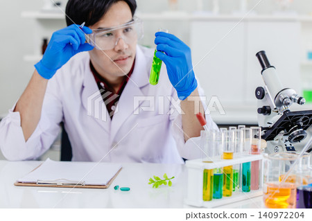 Asian young scientist working in science lab research new medicine, Develop new chlorophyll formula Asian young scientist working in science lab research new medicine, Develop new chlorophyll formula 140972204