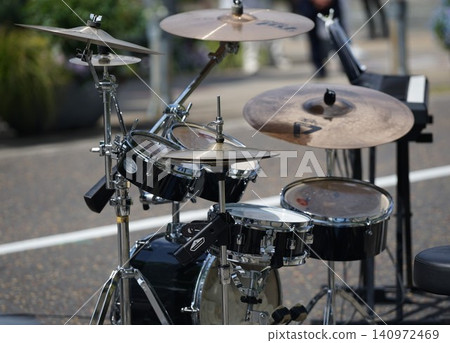 A drum set at a street event on a sunny day A drum set at a street event on a sunny day 140972469
