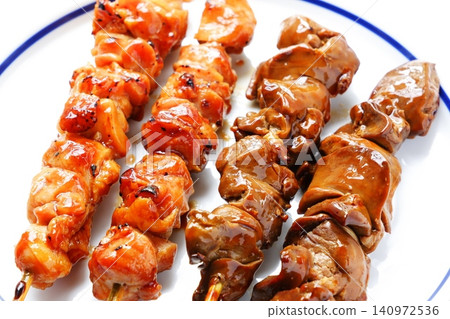 Yakitori - A platter of grilled chicken skewers (with sauce) that have been carefully cooked over charcoal. Yakitori - A platter of grilled chicken skewers (with sauce) that have been carefully cooked over charcoal. 140972536