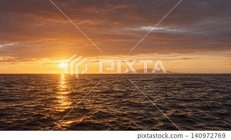 A breathtaking view of the sunset sinking into the sea and the golden shimmering surface of the water. A breathtaking view of the sunset sinking into the sea and the golden shimmering surface of the water. 140972769