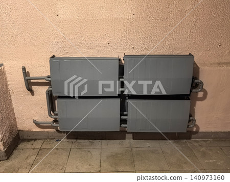 Four outdoor air conditioner condenser units mounted on building wall Four outdoor air conditioner condenser units mounted on building wall 140973160