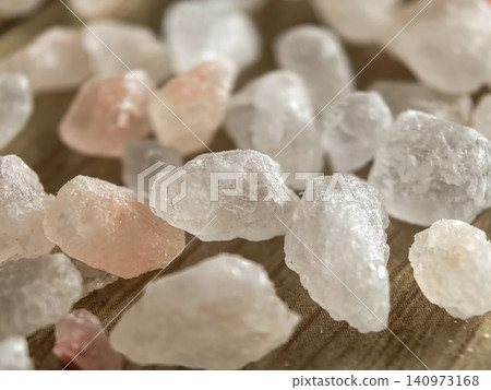 Macro close up of white rock salt crystals with pink Himalayan salt on fabric Macro close up of white rock salt crystals with pink Himalayan salt on fabric 140973168