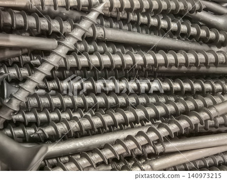 Close up of self tapping screw threads aligned in parallel rows Close up of self tapping screw threads aligned in parallel rows 140973215