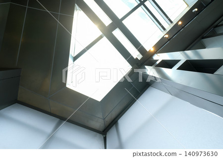 The low angle view of the building ceiling. Interior of modern architecture, modern city building. Interior design. Details of modern architecture. Building abstract. Building background. 140973630