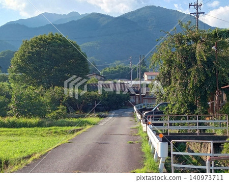 A residential area and road at the foot of a mountain. A residential area and road at the foot of a mountain. 140973711