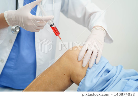 Asian doctor inject Hyaluronic acid platelet rich plasma into knee of senior woman. Asian doctor inject Hyaluronic acid platelet rich plasma into knee of senior woman. 140974058