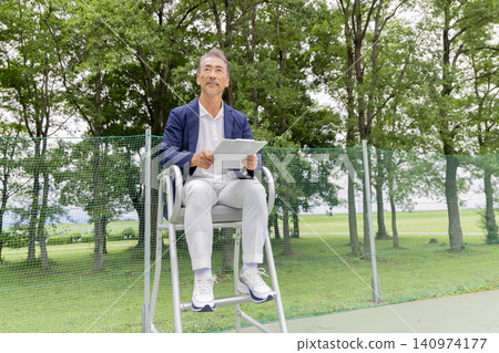 A male umpire watching a tennis match A male umpire watching a tennis match 140974177