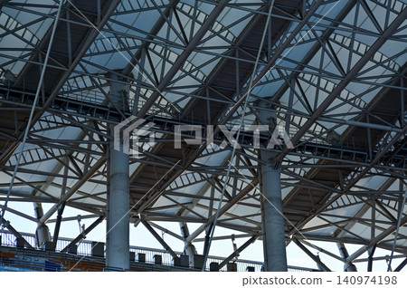 Close-up of the stadium ceiling. Modern architecture, modern city building. Exterior design. Details of modern architecture. Building abstract. Building background. Close-up of the stadium ceiling. Modern architecture, modern city building. Exterior design. Details of modern architecture. Building abstract. Building background. 140974198