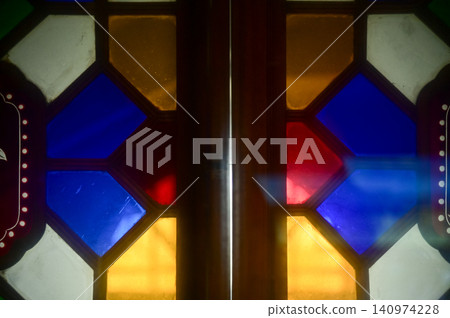 Colorful classic glass window with grid. Colorful abstract stained glass window pattern background. Classic pattern. Building abstract. Building background. Colorful classic glass window with grid. Colorful abstract stained glass window pattern background. Classic pattern. Building abstract. Building background. 140974228
