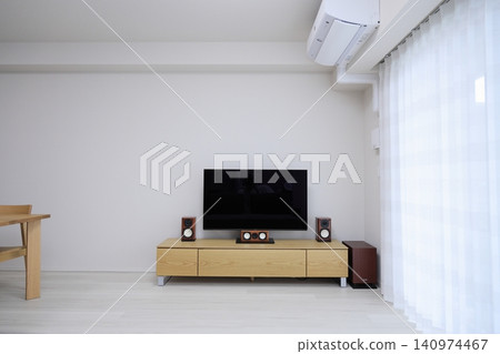 A large TV and home theater system mounted on a wooden TV stand. A large TV and home theater system mounted on a wooden TV stand. 140974467