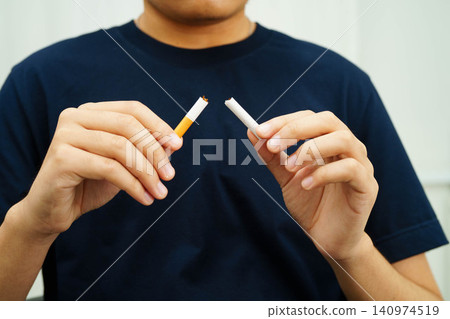 Quit smoking, Asian teenage man breaking destroy cigarette in hand. Quit smoking, Asian teenage man breaking destroy cigarette in hand. 140974519