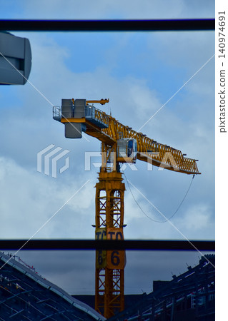 Crane truck working in construction site with sky background. Crane against sky. Crane, Construction background, construction equipment crane background. Crane truck working in construction site with sky background. Crane against sky. Crane, Construction background, construction equipment crane background. 140974691