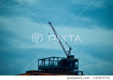Crane truck working in construction site with sky background. Crane against sky. Crane, Construction background, construction equipment crane background. Crane truck working in construction site with sky background. Crane against sky. Crane, Construction background, construction equipment crane background. 140974702