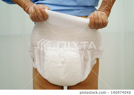 Asian senior woman patient wearing adult incontinence diaper pad in hospital. Asian senior woman patient wearing adult incontinence diaper pad in hospital. 140974848