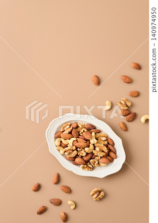 mixed nuts on a plate mixed nuts on a plate 140974950