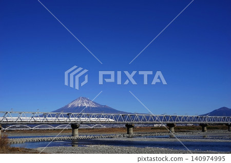 The Shinkansen bullet train and the Fujikawa Railway Bridge running in front of the mountain ranges of Mt. Fuji and Mt. Ashitaka. January. Mt. Fuji 2079, Mt. Ashitaka, Shinkansen, Fujikawa Railway Bridge. The Shinkansen bullet train and the Fujikawa Railway Bridge running in front of the mountain ranges of Mt. Fuji and Mt. Ashitaka. January. Mt. Fuji 2079, Mt. Ashitaka, Shinkansen, Fujikawa Railway Bridge. 140974995