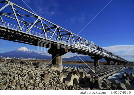 The Shinkansen bullet train crosses the Fujikawa Railway Bridge, seemingly flying over Mount Fuji. January, Mount Fuji 2084 Shinkansen and Fujikawa Railway Bridge The Shinkansen bullet train crosses the Fujikawa Railway Bridge, seemingly flying over Mount Fuji. January, Mount Fuji 2084 Shinkansen and Fujikawa Railway Bridge 140974999