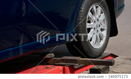 Car service,blue car on lift for changing wheel,auto repair Car service,blue car on lift for changing wheel,auto repair 140975173