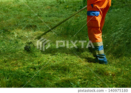 Landscaping work.Grass cutting with handle lawn mower Landscaping work.Grass cutting with handle lawn mower 140975180