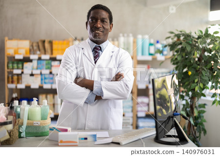Portrait of positive pharmacist or doctor in pharmacy closeup Portrait of positive pharmacist or doctor in pharmacy closeup 140976031