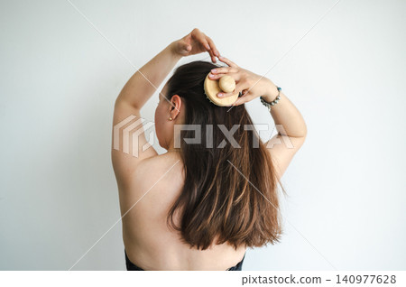 Woman Combing Hair - Daily Beauty Routine Woman Combing Hair - Daily Beauty Routine 140977628