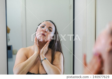 Beauty Portrait of Woman Applying Face Cream Beauty Portrait of Woman Applying Face Cream 140977629